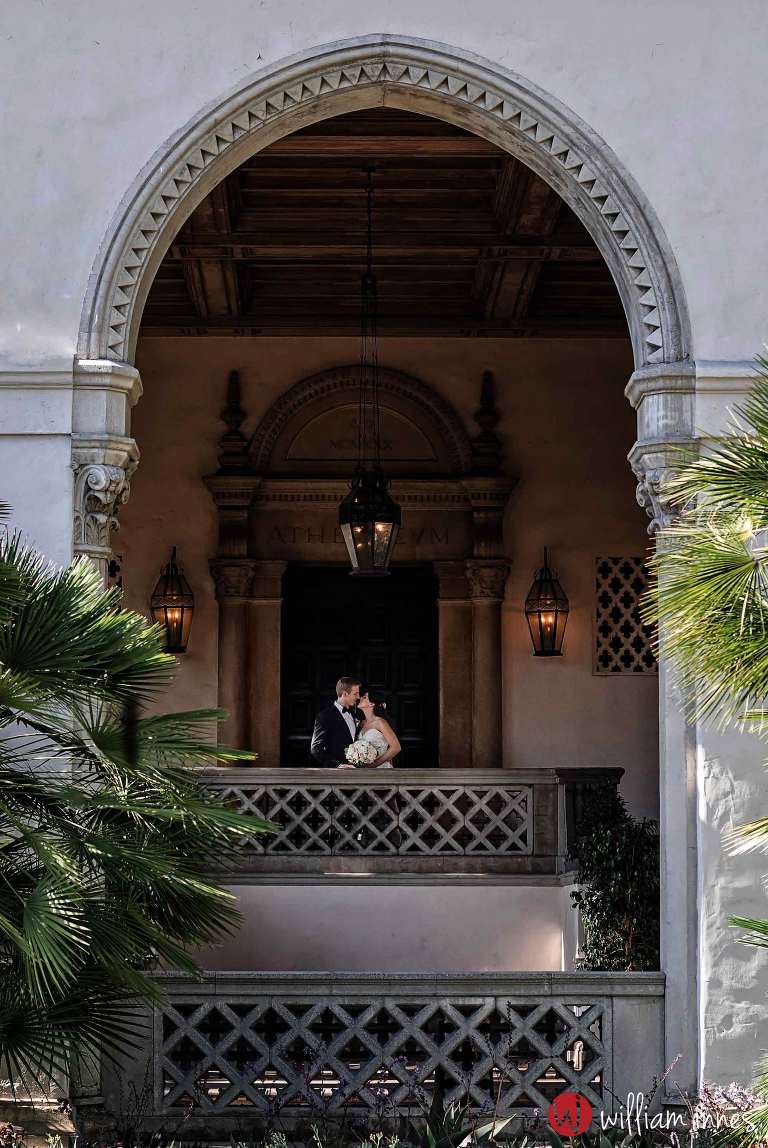 bride and groom in arch way at wedding at The Athenaeum Pasadena