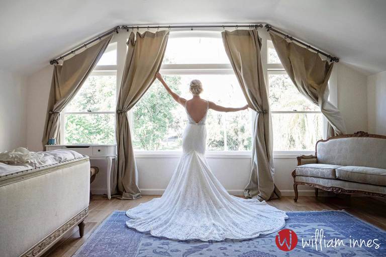 bride in the window at a newhall mansion wedding